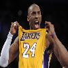 Static image of a basketball player holding up a yellow jersey with visible text and numbers, set against a dark background.