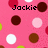 Pixelated pink background with scattered brown, white, and red circular shapes and the name "Jackie" in black pixelated text.