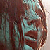 Pixelated static image of a person with brown hair and a teal-toned face, cropped to show only the upper head and shoulders against a dark background.