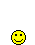 Yellow smiley face with red brick-like objects falling and accumulating around it on gray background.