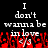 Pixelated text reads "I don't wanna be in love" with red splatter effects on a black background.
