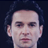 Static pixelated image of a person's face with dark hair, light skin tone, and closed eyes against a solid black background.