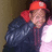Pixelated image of a person wearing a red cap and dark jacket, with a blurred background and visible pixelation artifacts.