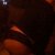 Dark brown and orange abstract shapes with a small blue pixel cluster in the top-left corner, transitioning to a white background on the right side.