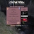 A pixelated static image shows a pink rectangular document with faint text, positioned next to a dark mechanical device featuring red and white elements against a blurred background.