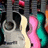 Pixelated image with pink background, blue text phrases, and a small guitar section on the left.