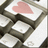 A static image shows a keyboard with a heart-shaped key, surrounded by red text on a red background.