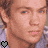Two side-by-side pixelated images of a person with brown hair wearing a light purple shirt, each featuring a heart symbol in the bottom corner.