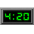 Two adjacent digital displays show green pixelated numbers on black backgrounds with gray borders, one displaying '4:20' and the other showing '4 20'.