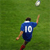Pixelated static image of a soccer player in blue jersey kicking a ball on green field background.
