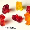 Six translucent gummy bear-shaped objects in red, orange, and yellow hues arranged on a light background with pixelated text below.
