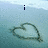Pixelated heart drawing on light blue background with text elements above and below, showing animation changes across frames.