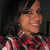 A person with dark hair and a red plaid shirt appears in three views showing slight head movement against a dark background.