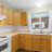 Pixelated kitchen scene with wooden cabinets, a white countertop, and a stove with visible burners.