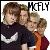 Three people in close physical proximity, one wearing a dark shirt with white graphic, another in orange, and the third in dark clothing, with 'McFLY' text above them.