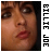 Pixelated close-up of a person's face with brown hair, red lips, and visible eyes; vertical text 'BILIE JOE' in black block letters on the right side.