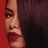 Pixelated close-up of a person's face with red hair and dark background, displayed as a static AIM buddy icon.