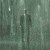 A pixelated figure in a dark suit stands in a rain-swept cityscape with vertical light streaks, shifting between three distinct poses