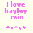Pixelated pink text reads "i love hayley rain" above five small heart symbols on a light background, with one heart changing color between frames.