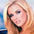 Static pixelated image of a person with long blonde hair and light skin tone, wearing dark clothing against a blurred background.