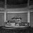 Black-and-white pixelated image of a rectangular frame with a central dark horizontal bar and scattered light and dark pixels below it.