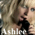 A pixelated collage of three views showing a blonde woman singing into a microphone with the name 'Ashlee' overlaid in white text.