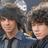 A person with dark curly hair and a blue jacket appears in multiple showing slight head movement