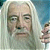 Pixelated static image of a person with long white hair and neutral expression, partially cropped on the right side showing additional figures in background.