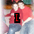 A static image of two people in red shirts and blue jeans with text overlays changing from 'I' to 'LOVE' to 'KYLE'.