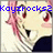 Pixelated image of a character with pink hair and red lips, overlaid with blue text reading 'KoyiRocks2' against a light background.
