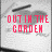 Pixelated grayscale background with red text reading 'OUT IN THE GARDEN' and a black horizontal line above the text.
