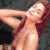 A pixelated image of a person with long brown hair lying on their back, arms raised behind head, against dark background; green text reads 'Original Icons .com' in stylized font.
