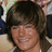 Pixelated image of a smiling person with brown hair, next to cyan text reading 'Zac Efron' and 'IS SOOOOOO HOT' on black background.