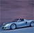 Pixelated image of a light blue convertible car with dark blue accents on a gradient purple background.