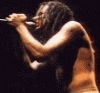 A shirtless person with long dark hair sings into a microphone on stage, captured in six showing slight movement