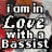 Four identical display text 'i am in Love with a Bassist' over a blurred background, each showing one red heart symbol at different positions