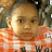 A 48x48 pixel animated buddy icon featuring a split composition with a child in an orange striped shirt on the left and "Johnson Family Vacation" text on a green background on the right, displayed as two sampled frames from an animation.