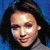 Pixelated close-up of a person with dark hair against a blue background, showing partial facial features and clothing.