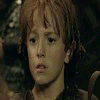 A child with red hair and a dark outfit appears in four showing helmet adjustment