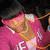 A person in a pink hoodie with white text and a gold chain necklace appears in a of four , with the bottom-left showing pink text reading 'Poota' over the image