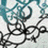 Pixelated static image with abstract black line patterns on a light background, featuring teal and white pixel clusters in the upper portion.