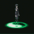 Animated figure in dark clothing stands on glowing green circular platform with concentric rings, background shifts from single to multiple platforms.