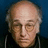 Static pixelated image of a person with light skin, balding hair, and closed eyes against dark blue background.