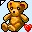 Pixelated teddy bear with brown fur, black eyes and nose, green accents on arms, red heart icon to the right, light blue background.