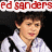 A pixelated image of a person with short dark hair wearing a white shirt and black straps, positioned under red text reading 'ed sanders' on the left side.
