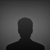 Pixelated silhouette of a human figure against a gradient gray background with no visible facial features or clothing details.