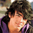 Pixelated image of a person with dark wavy hair wearing a purple garment, alongside text and a bird logo.