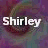 Two side-by-side animated frames of a buddy icon showing the name "Shirley" in white text over a blurred, colorful background with swirling patterns.