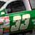 Green race car with white number 33 and sponsor logos, shown in multiple views including side profile and full vehicle.