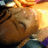 Animated sequence showing a character's face with closed eyes, transitioning from a bright orange background to a gray background.